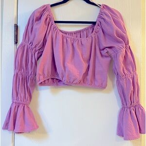 Free People cropped top with bell and three section sleeves. Pink/purple XS NWOT